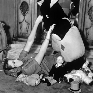 LISTEN DARLING, Judy Garland enjoying the company of various dolls and stuffed animals on set, 1938