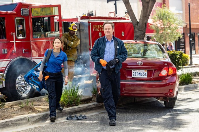 young woman and man with fire trucks and red car in Code 3