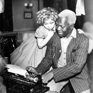 THE LITTLEST REBEL, Bill Robinson (right) helping Shirley Temple answer fan letters from Movie Mirror magazine readers, on set, 1935. ©20th Century-Fox Film Corporation, TM & Copyright