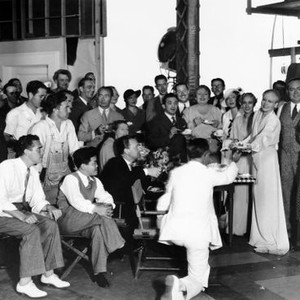 BIOGRAPHY OF A BACHELOR GIRL, celebrating Ann Harding's 34th birthday on-set are, cinematographer James Wong Howe, (sitting, second from left), assistant director Harry Sharrock, (back to camera), and, standing, right, stand-in Phyllis Yates, Yates's siste