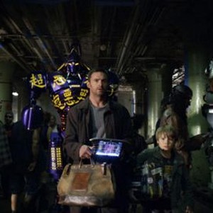 "REAL STEEL"  RS-FF-006  Down-on-his-luck fight promoter Charlie Kenton (Hugh Jackman, left) and his son, Max (Dakota Goyo, right) enter their star robot boxer Noisy Boy in a match at the Crash Palace in DreamWorks Pictures' action drama "Real Steel".  Â©D