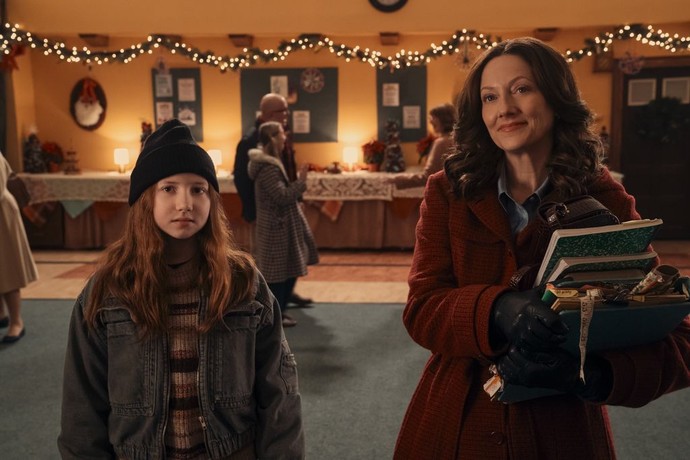 Imogene Herdman (Beatrice Schneider, L) and Grace Bradley (Judy Greer) stand in front of a picture of Mary, the mother of Jesus, and Imogen is concerned she's not pretty enough to play her,  in “The Best Christmas Pageant Ever.” (Lionsgate)