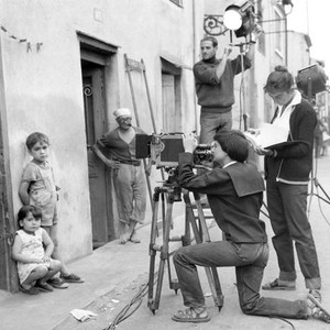 LA POINTE-COURTE, writer/director Agnes Varda (kneeling at  camera), on set, 1955