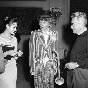 THE JOKER IS WILD, Carmen Sevilla (left) visiting with Frank Sinatra (center) and director Charles Vidor (right), between scenes, on set, 1957