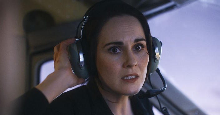 Madolyn (Michelle Dockery) attempts to pilot a plane with no experience, while trying to figure out which of her bosses is double-crossing her, in "Flight Risk." (Lionsgate)