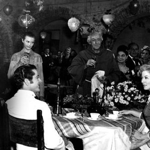 STRANGE LADY IN TOWN, stading from left: Cameron Mitchell (far left), Lois Smith (bolo tie), Walter Hampden (priest); seated from left: Dana Andrews, Greer Garson, 1955