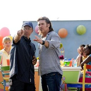 HANNAH MONTANA: THE MOVIE, foreground from left: director Peter Chelsom, Billy Ray Cyrus, on set, 2009. Photo: Sam Emerson/ ©Walt Disney Co.