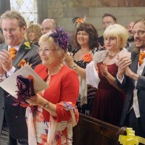ONE CHANCE, Colm Meaney (front left), Julie Walters (flower in hair), Jemima Rooper (right, red dress), Mackenzie Crook (right), 2013./©Weinstein Co.