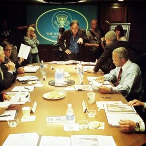 W., (aka W), standing in center: director Oliver Stone, seated at table clockwise from far left: Thandie Newton as Condoleezza Rice, Scott Glenn as Donald Rumsfeld, Bruce McGill as George Tenet, Josh Brolin as George W. Bush, Jeffrey Wright as Colin Powell