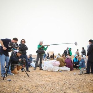 HE NAMED ME MALALA, cinematographer Erich Rolland (at camera), director Davis Guggenheim (arms folded), Malala Yousafzai (white sari), Ziauddin Yousafzai (standing, foreground right) at the Jordan/Syrian border, February 16, 2014, 2015. TM & copyright © Fox Searchlight Pictures. All rights reserved.