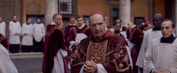 Cardinal Lawrence (Ralph Fiennes, center) is in charge of the proceedings, in "Conclave." (Focus Features)