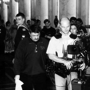 RUSSIAN ARK, director Aleksandr Sokurov (center, in glasses, looking down), cinematographer Tilman Buttner (holding Steadicam), on set, 2002. ©Wellspring