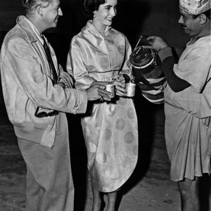 QUO VADIS, director Mervyn LeRoy (left) with visitor Elizabeth Taylor (center) on set, 1951