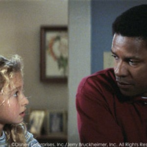 Hayden Panettiere (left) stars as Sheryl Yoast, daughter of the high school football coach replaced by Herman Boone (Academy Awardr winner Denzel Washington, right).