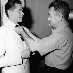 GILDA, director Charles Vidor, straightening Glenn Ford's tie, on-set, 1946