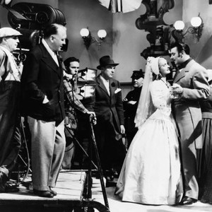 THE OLD MAID, director Edmund Goulding (hand in pocket) filming a scene with Bette Davis, George Brent, 1939