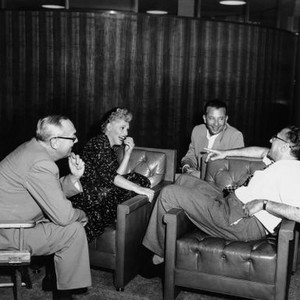 IT SHOULD HAPPEN TO YOU, from left, Arthur Willis, Judy Holliday, producer Fred Kohlmar, director George Cukor, on-set, 1954