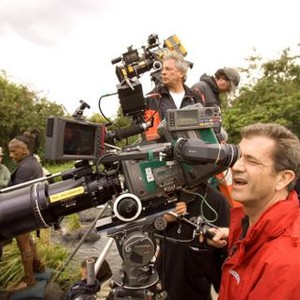 APOCALYPTO, cinematographer Dean Semler (center, background), director Mel Gibson (right), on set, 2006. ©Walt Disney Co.