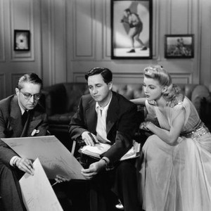 JOHNNY EAGER, from left, costume designer Robert Kalloch, director Mervyn LeRoy, Lana Turner, poring over costume sketches, September 1941