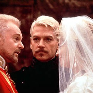 Claudius (Derek Jacobi, left) and Gertrude (Julie Christie, right) are wed as Hamlet (Kenneth Branagh, center) looks on.