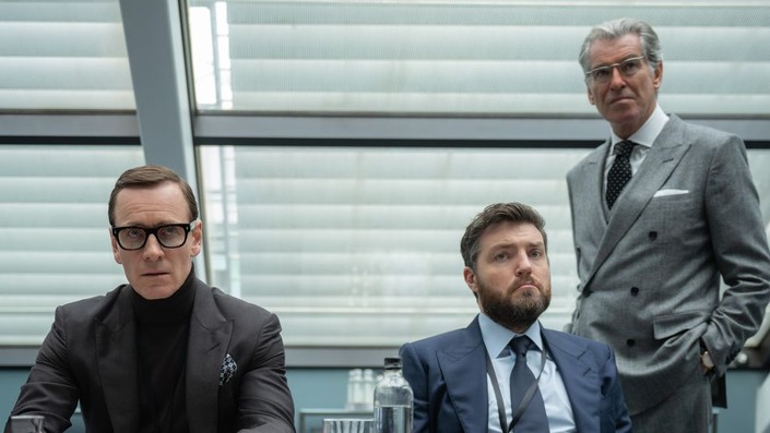 (L–R) George Woodhouse (Michael Fassbender), Freddie Smalls (Tom Burke), and Arthur Stieglitz (Pierce Brosnan) discuss spy agency internal affairs, in "Black Bag." (Focus Features)