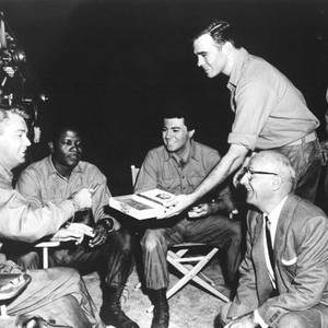 ALL THE YOUNG MEN, from left: Alan Ladd, Sidney Poitier, James Darren, Glenn Corbett, Paul Richards, sharing a box of cigars, on set, 1960.