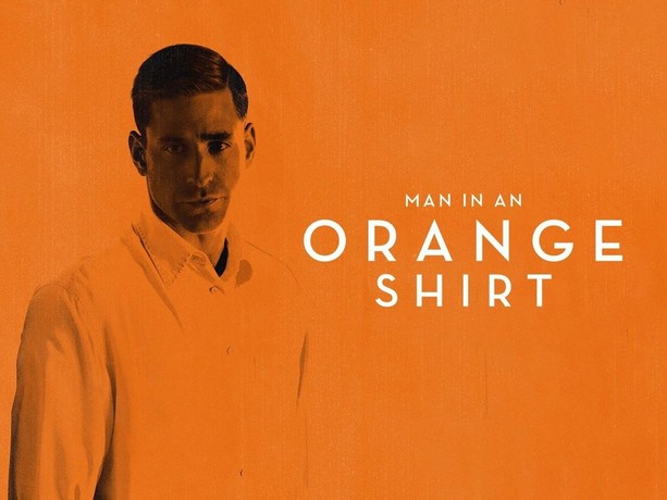 The man in a orange shirt deals