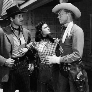 THE FIGHTING REDHEAD, from left: John Hart, Peggy Stewart, Jim Bannon, 1949