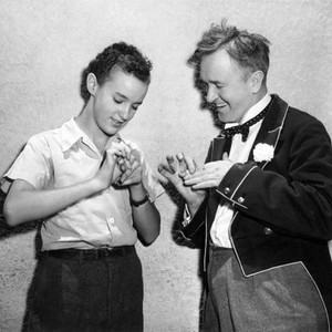 NOTHING BUT TROUBLE, David Leland being taught a hand trick by Stan Laurel on set, 1944
