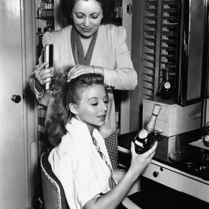 THE DESPERADOES, Evelyn Keyes, having her hair done by Helen Hunt, in her dressing room, 1943