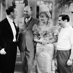 THE MERRY WIDOW, Baron Maurice de Rothschild (second from left) visits from left: Maurice Chevalier, Jeanette MacDonald, director Ernst Lubitsch on set, 1934