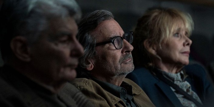 (L–R) Simon Pearce (Richard Benjamin), Peter Pearce (Griffin Dunne), and Maria Pearce (Rosanna Arquette) at the movies, in "Ex-Husbands." (Greenwich Entertainment)