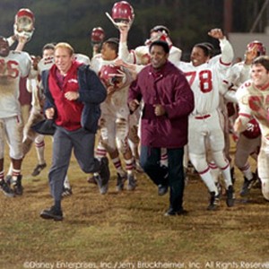 Will Patton (center, left) and Denzel Washington (center, right) star as high school football coaches Bill Yoast and Herman Boone.