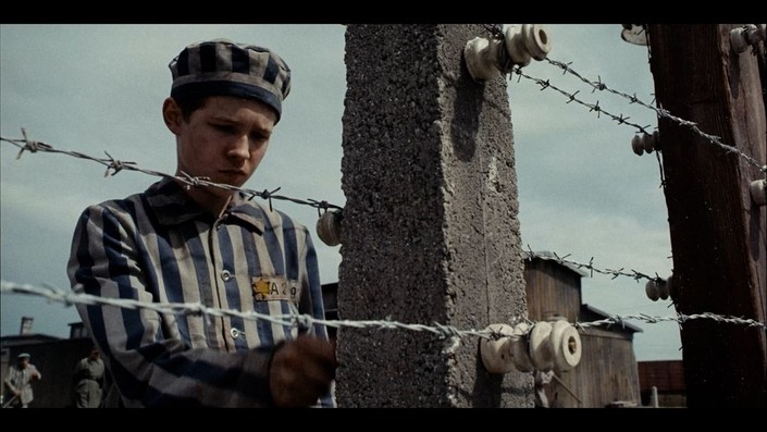 young boy dressed in prison garb in The Optimist: The Bravest Act Is Truth