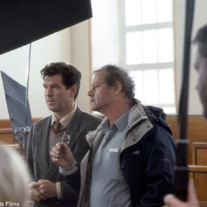 PIERCE BROSNAN discusses a scene with director BRUCE BERESFORD on the set of United Artists' inspiring drama EVELYN. photo 18