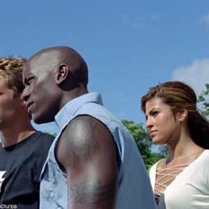 Orange Julius (AMAURY NOLASCO, left), Suki (DEVON AOKI) and Slapjack (MICHAEL EALY, right) surround Brian O'Connor (PAUL WALKER, third from left) who is back and ready to race.