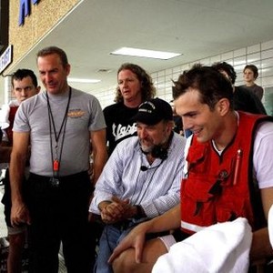 THE GUARDIAN, Kevin Costner, director Andrew Davis, Ashton Kutcher watching playback on set, 2006, (c) Touchstone