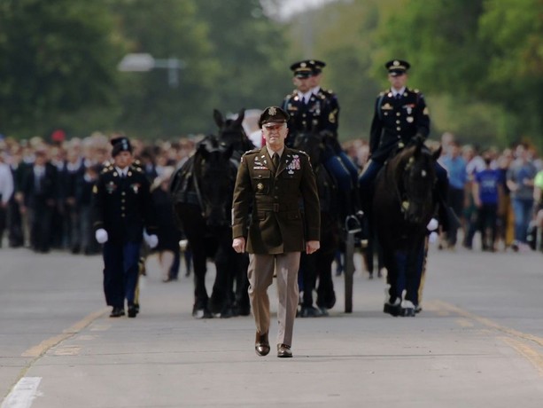 U.S. military veterans marching in a parade, in “Fighting Spirit: A Combat Chaplain’s Journey.” (Paulist Productions)