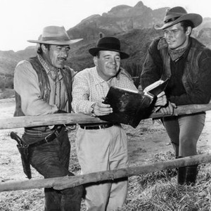THREE VIOLENT PEOPLE, from left: Gilbert Roland, director Rudolph Mate, Charlton Heston on set, 1956