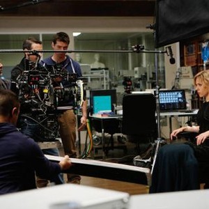 LUCY, director Luc Besson (back left), Scarlett Johansson (right), on set, 2014. ph: Jessica Forde/©Universal Pictures