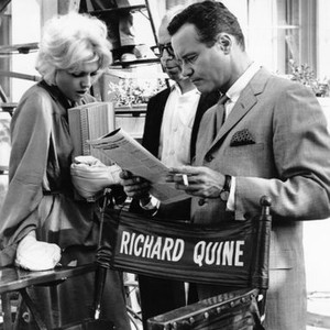 THE NOTORIOUS LANDLADY, Kim Novak (left), Jack Lemmon at director Richard Quine's chair on set, 1962