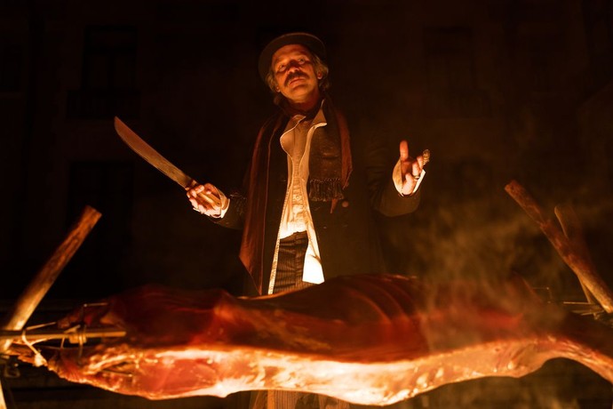 Due to a food shortage, Floyd Monk (Peter Saarsgard) roasts venison he hunted himself, in "Coup!" Unfortunately his boss is a, er, vegan. Actually vegetarian since it's 1918. (Spencer Pazer/Greenwich Entertainment)