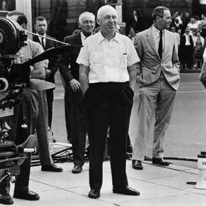 ADVISE AND CONSENT, director Otto Preminger (center, hands in pockets), Henry Fonda (looking right) on set, 1962