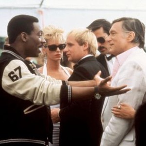 BEVERLY HILLS COP II, Jurgen Prochnow (crew cut, left), Eddie Murphy (team jacket), Hugh Hefner (white suit), 1987, ©Paramount