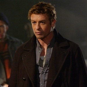 Mercenaries Riley (SIMON BAKER, right) and Charlie (ROBERT JOY, background) are deployed by the leaders of a walled city.