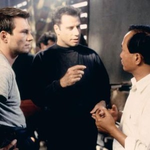 BROKEN ARROW, Christian Slater, John Travolta, director John Woo on set, 1996, TM and Copyright (c)20th Century Fox Film Corp. All rights reserved.