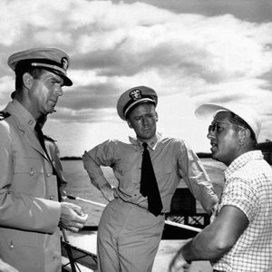 THE CAINE MUTINY, from left, Fred MacMurray, Van Johnson, director Edward Dmytryk, on location in Pearl Harbor, 1954