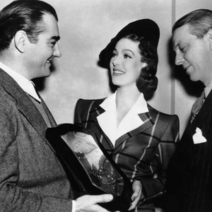 THE DOCTOR TAKES A WIFE, prodicer William Perlberg, (left), ditrector Alexander Hall, (right) present Loretta Young with the 1939 Voice Personality Sward from the American Institute of Voice Teachers, April 1940