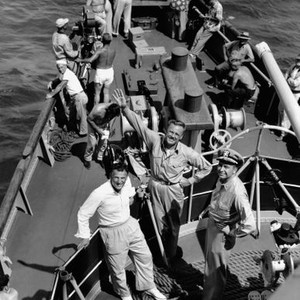 THE CAINE MUTINY, from left, front, producer Stanley Kramer, Van Johnson, technical advisor James Shaw, on location in Pearl Harbor, 1954