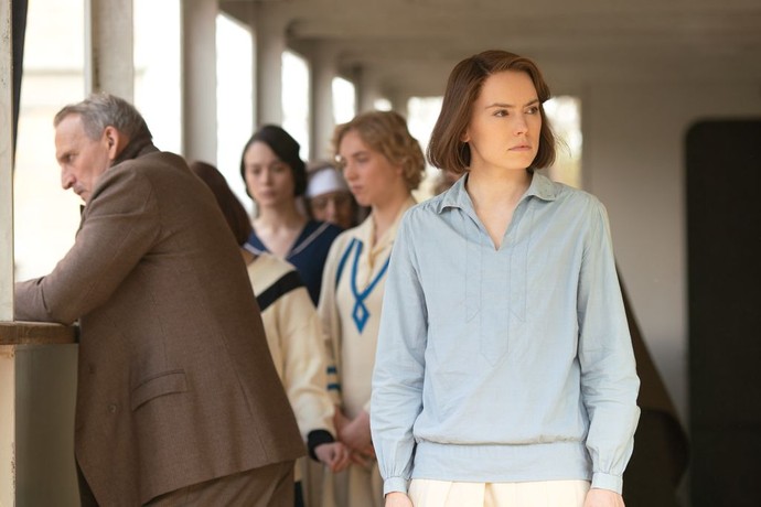 Swim coach Jabez Wolffe (Christopher Eccleston, L), and Trudy Ederle (Daisy Ridley, far right) onboard the ship headed to the 1924 Paris Olympics, in "Young Woman and the Sea." (Walt Disney Studios)